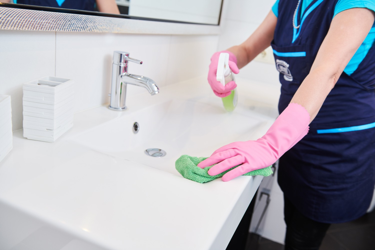 home cleaning services in protective gloves cleaning bathroom countertop